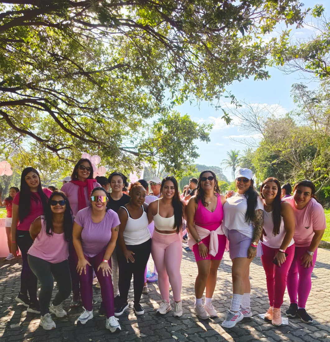 Grupo de participantes sorrindo sob as árvores do Parque Ecológico da Pampulha